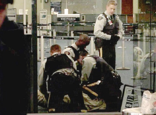 >Frame grab from a video shot by Paul Pritchard at Vancouver airport where he witnessed the Tasering of Robert Dziekanski in October 2007. RCMP Cpl. Monty Robinson is seen at right kneeling on Dziekanski. — handout photo