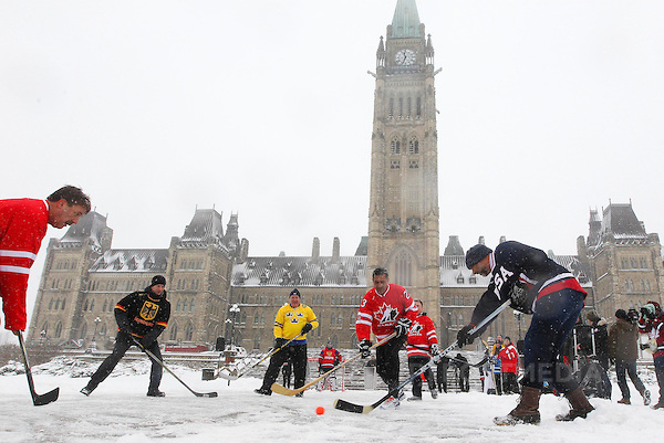 QMIPHOTOSOFTHEWEEKMAR22--Minister of State (Sport)  Bal Gosal (R in Canada jersey) with NDP MP Peter Stoffer (L) and Hockey Canada staff play a ball hockey against foreign embassy staff next to the steps leading to Parliament Hill in Ottawa March 19, 2013. The event was held to promote the upcoming 2013 IIHF Ice Hockey Women's World Championship which will be held in Ottawa from April 2 to 9.  Andre Forget/QMI Agency